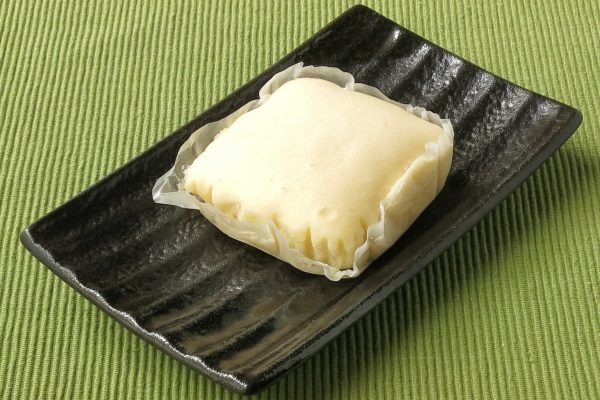 グラシン紙に収まった四角い蒸しケーキ。